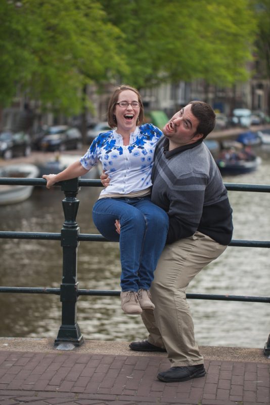 Couple having fun at Amsterdam canal in the summer
