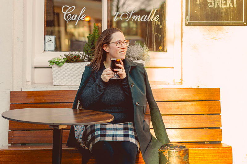woman on a bench drinking mulled wine